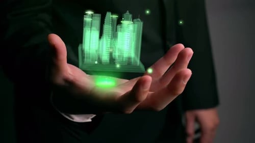 Geschäftsmann hält 3D-Stadtmodell in der Hand, das Augmented-Reality-Technologie zeigt