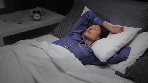 Woman Sleeping in Bed