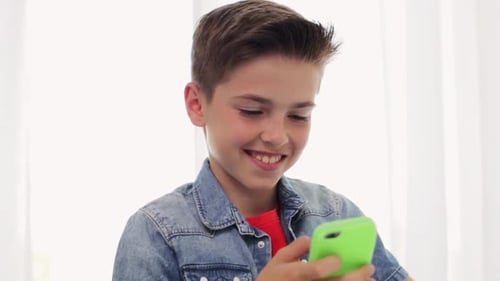 Smiling Boy Using Mobile Phone