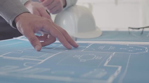 Architects Viewing Blueprint in Workplace Setting