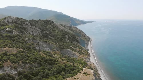 Top View Tropical Forest and Emerald Clear Water. Azure Beach with Rocky Mountains and Clear Water