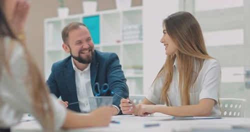 Happy Beautiful Girl Talking with Colleagues at a Company Meeting Smiling and Laughing