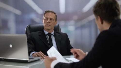 Businessmen Reviewing Documents in Modern Office