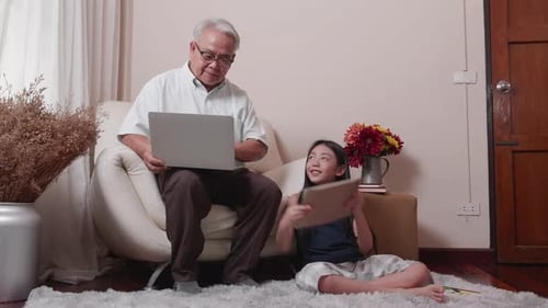 Grandfather and Granddaughter Using Technology Together