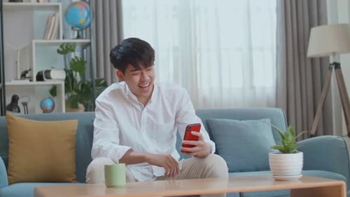 Smiling Young Adult on Smartphone Video Call