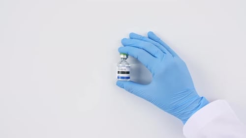 Hand Holds COVID-19 Vaccine Vial