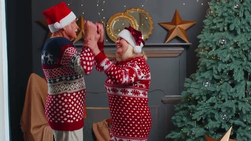 Senior Couple Dancing Joyfully at Christmas Time