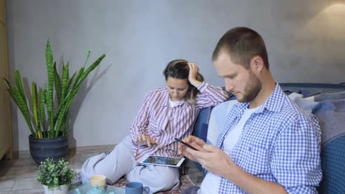 Man and Woman Relaxing with Digital Devices