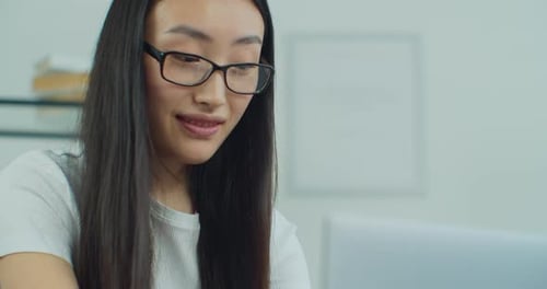 Close Up View of Asian Woman Eyes with Glasses Freelancer Works in Home on Laptop