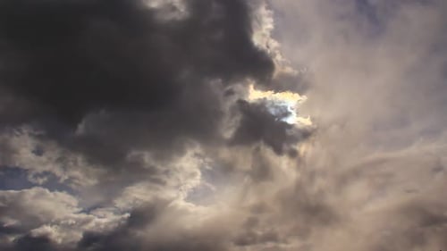 Sun Shining Through Dark Dramatic Cloudscape Time-Lapse