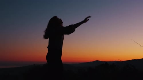 silhouette of happy girl for the arrival of summer