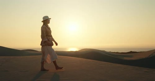 Lonely Girl Walking Barefoot on Rippled Sand Dune in Desert