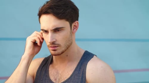 Close Up of Professional Sportsman Listening Music on Track