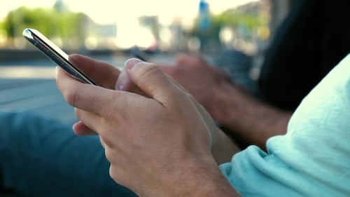 Young Adults Using Smartphones in City Environment