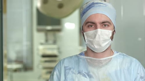 Experienced Young Surgeon, Serious Man Wearing Face Mask Looking Into Camera
