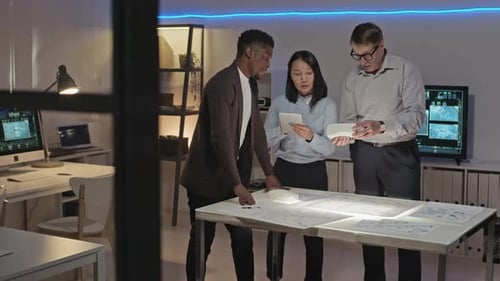 Engineering Team Collaborating on Automotive Design at Night