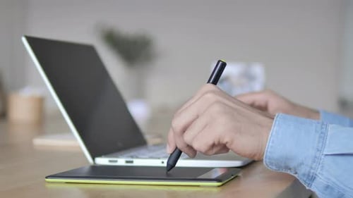 Hands Using Stylus and Tablet with Laptop