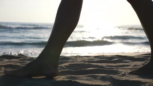 Legs of Woman Going on Sand Beach with Beautiful Seascape at Background. Close Up of Female Feet