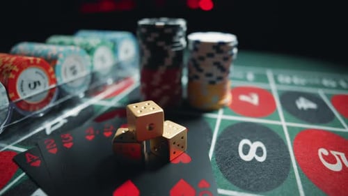Casino Chips with Dice and Playing Cards on a Dark Table
