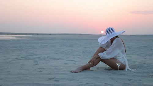 Stylish Woman in Hat Relaxing on Beach
