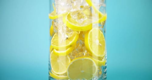 Lemon Slices and Ice Cubes in Glass