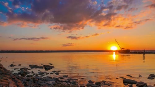 Sunset over the River with Boat in the Background