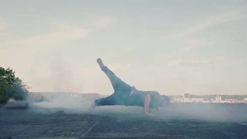 Dynamic Breakdancer Performs Stunts on Urban Rooftop
