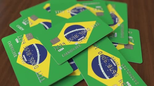 Brazilian Flag Credit Cards Piled on Wooden Table