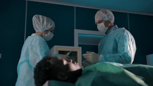 Medical Staff Attending to Patient in Operating Room