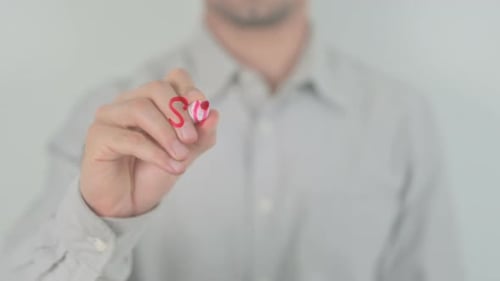 Man Writes the Word 'Successful' in Red Marker