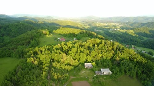 Countryside Village With Houses And Lush Tree Foliage At Spring In Slovenia. aerial drone ascend