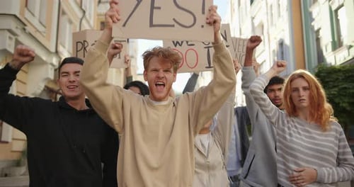 Public Demonstration of Angry Activists Students with Posters at City Streets