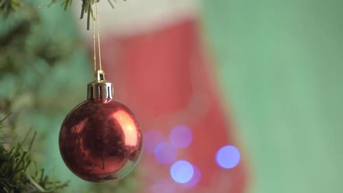 Red Christmas Ornament Hanging From Pine Tree Branch