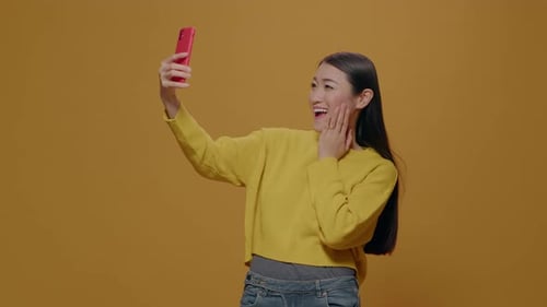 Cheerful Person Taking Selfies with Smartphone in Studio