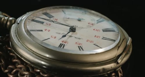 Macro shot of an antique pocket watch on a dark background