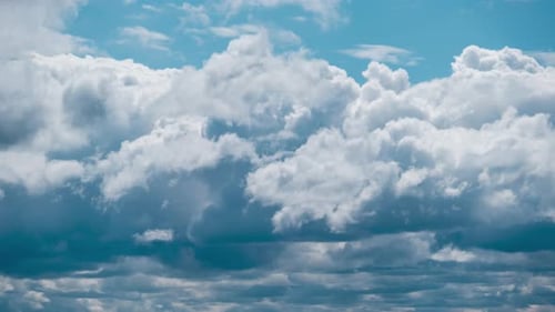 White Clouds Moving Across Blue Sky Time Lapse