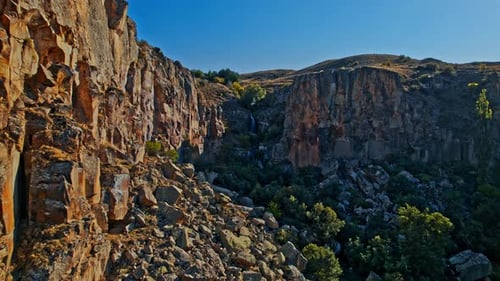 Scenic Waterfall and Cliffs in Rural Landscape