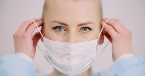Woman Put Protective Mask on Face