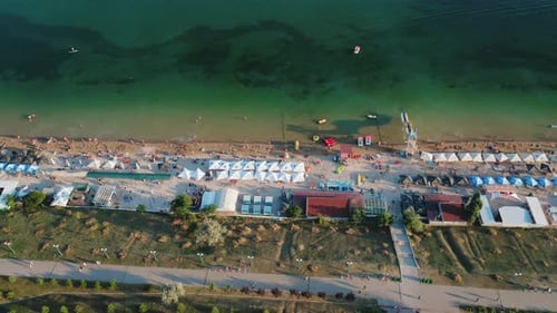 Aerial View of People Resting on a Summer City Beach in the Evening