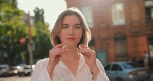 Woman Wearing Wireless Earbuds in a Summer City Slow Motion