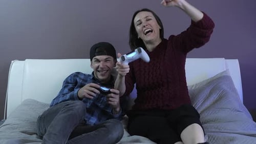 Couple Gaming Together, Woman Wins, Celebrates