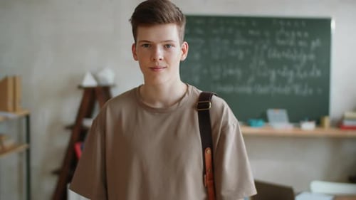 Teen Student Poses in Classroom with Backpack