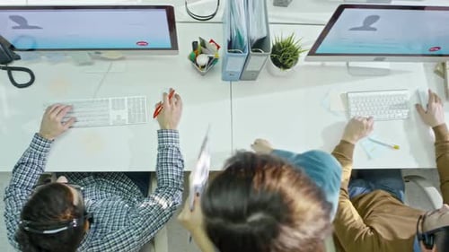 Aerial View of Three People Working at Desks