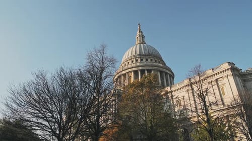 Popular London tourist attraction and landmark of St Pauls Cathedral on a bright blue sky day with A