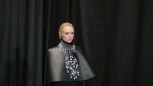 Elegant Woman Modeling High Fashion Cape Design