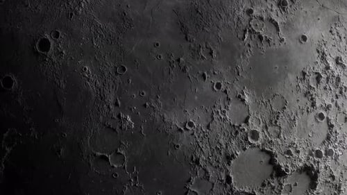 close-up of the moon. flight of the camera from the darkness to the illuminated surface of the moon