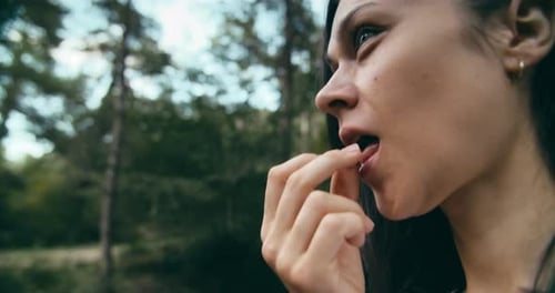 Woman on Hiking Trip in Forest Eating Wild Growing Organic Blackberry and Smile
