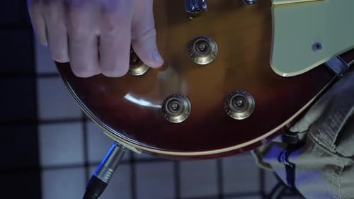 Guitar being adjusted in close up shot