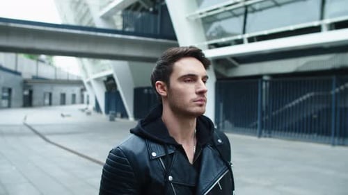 Closeup Handsome Man Walking on Emty City. Focused Male Model Walking on Street