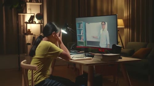 Teenage Girl Headache While Distance Learning With Online Teacher On Computer Screen From Home
